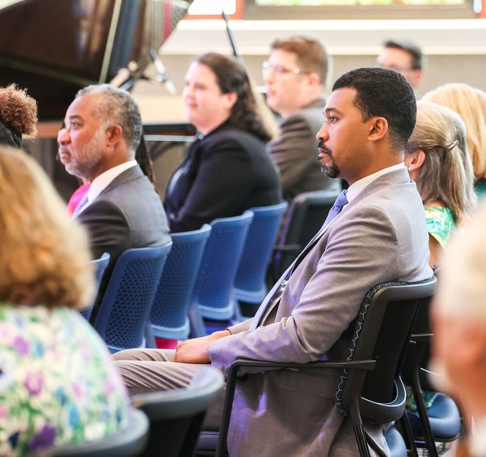 Attendees listening attentively at a formal event