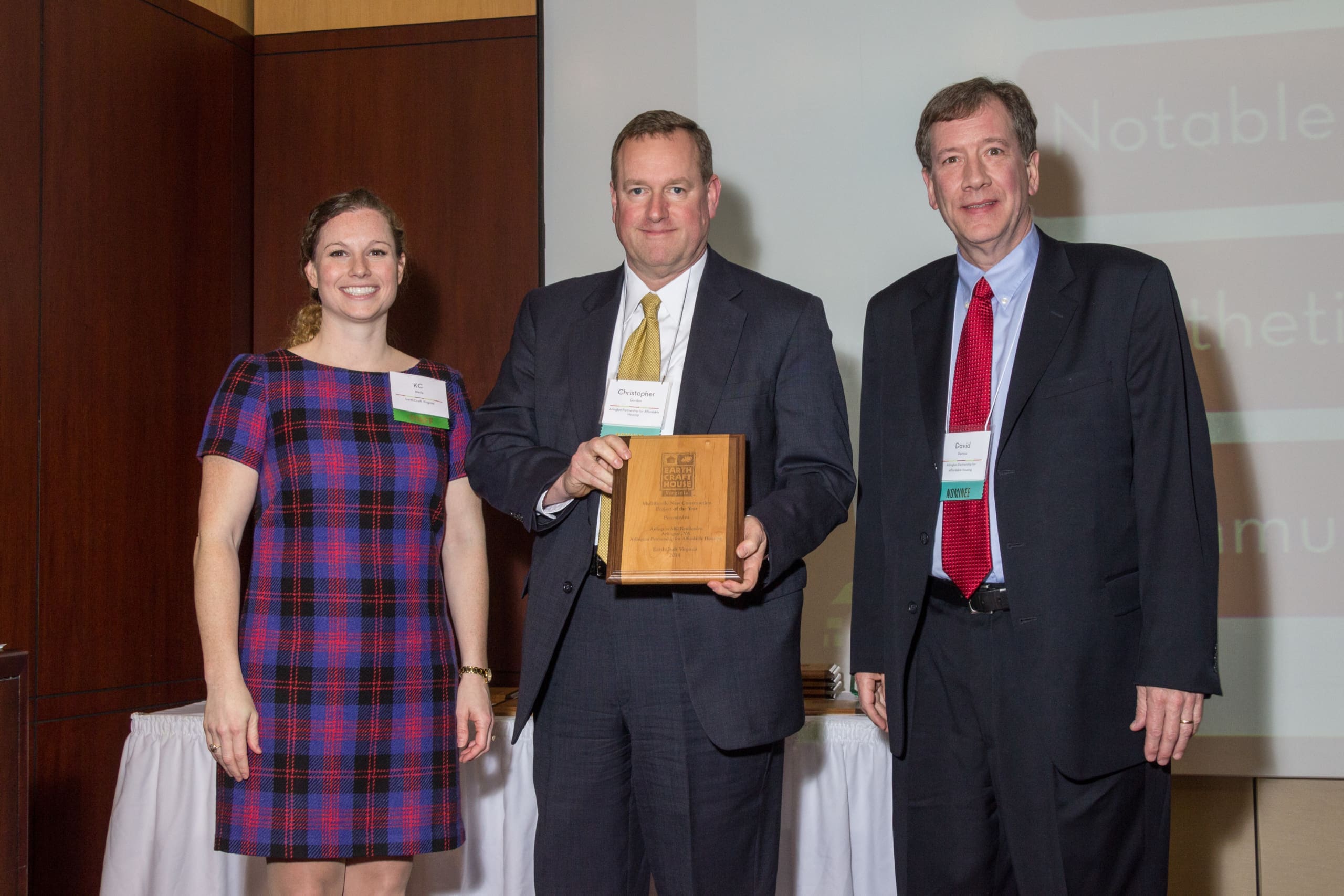 Three professionals at award presentation event