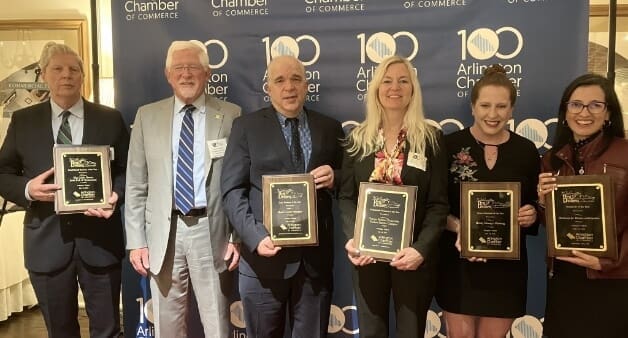 Group of six award recipients holding plaques at the Arlington Chamber of Commerce event