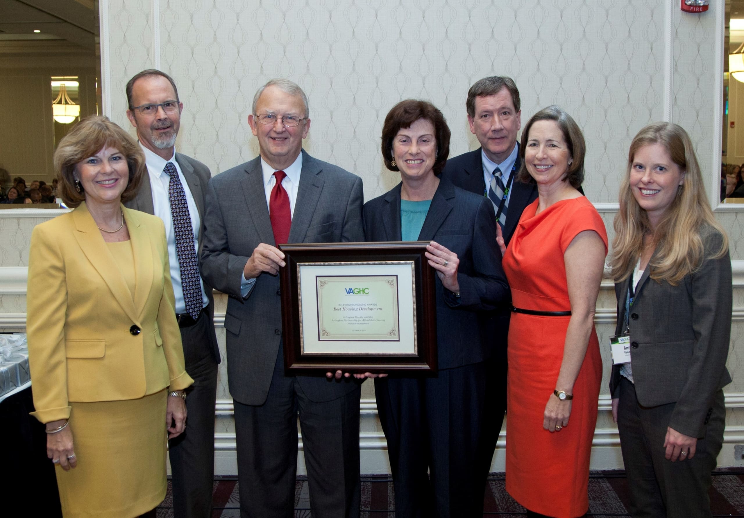 Group of seven people receiving an award at a VAGHC event